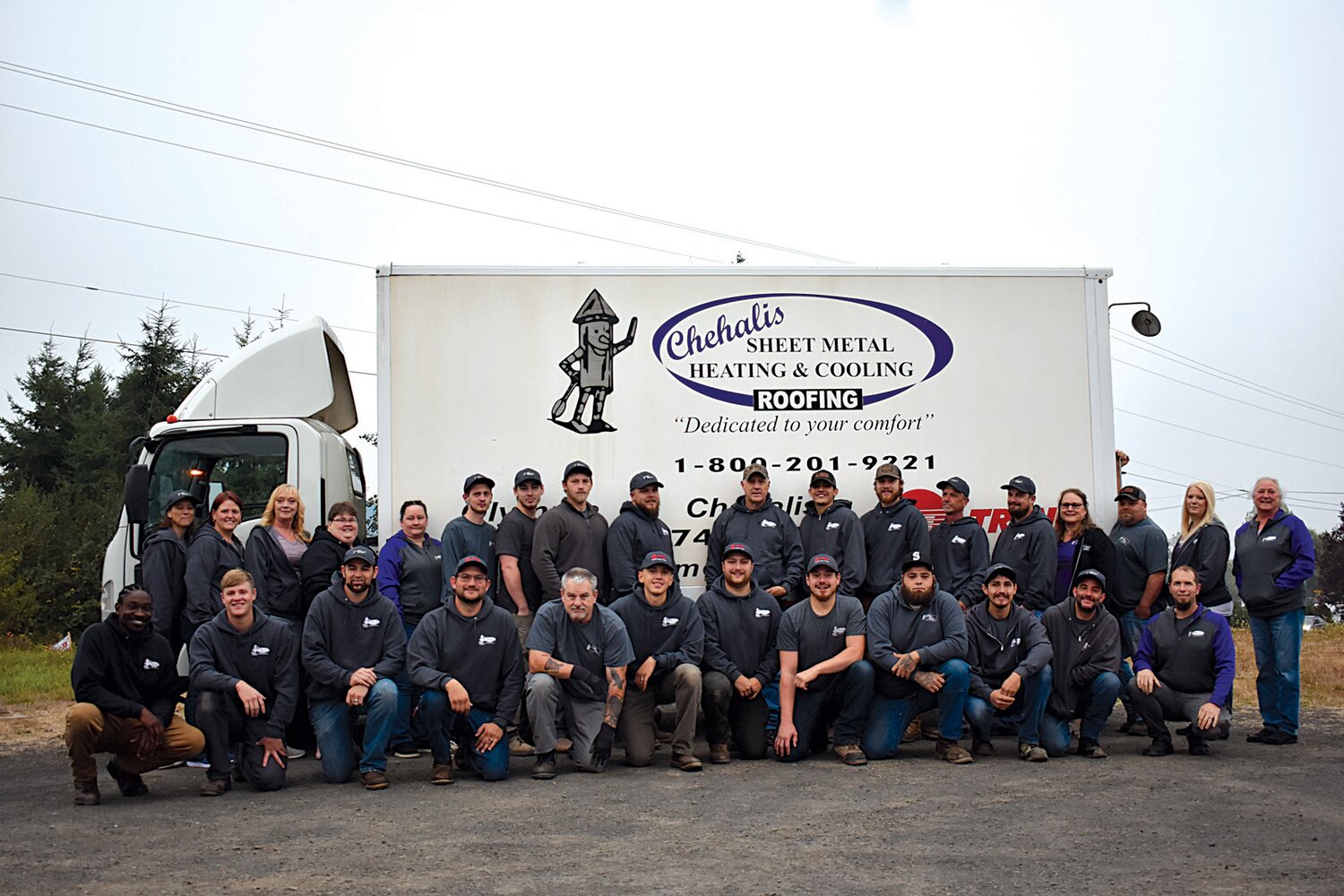 Employees of Chehalis Sheet Metal pose in front of the company's Chehalis location in this photo provided by the company. The company will give away a new heating and cooling system, valued at more than $5,000, to a family in need later this year.